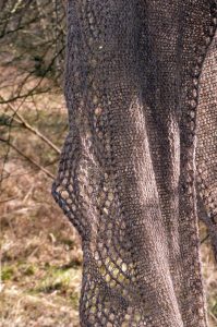 Grey lace shawll hanging from tree